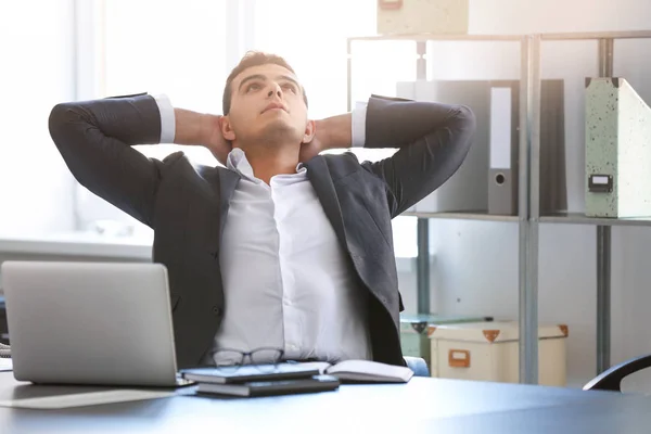 Young man in office resting at workplace — Stock Photo, Image