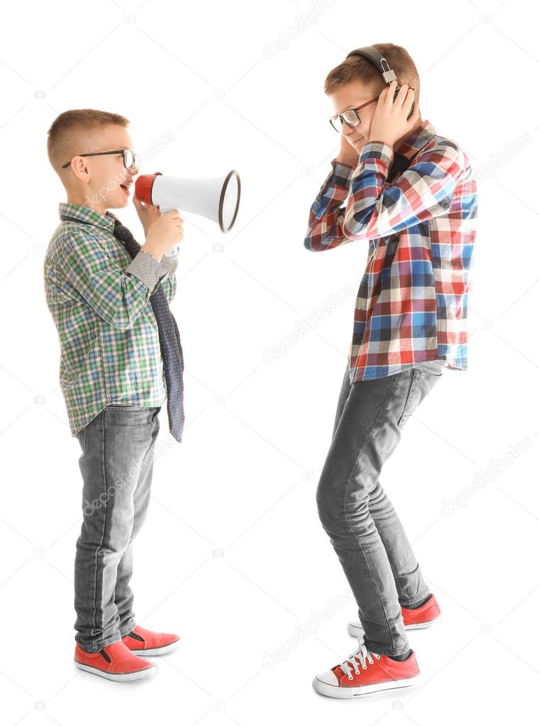 Cute little boy ignoring his friend with megaphone, on white background