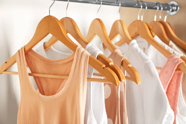 Hangers with different clothes in wardrobe closet — Stock Photo, Image