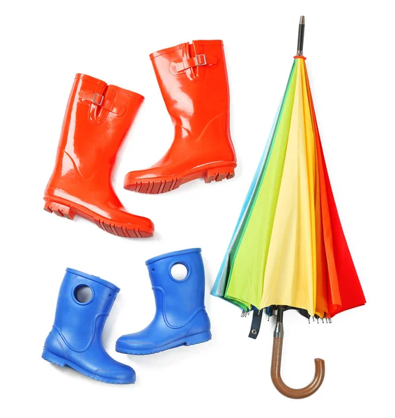 Rainbow umbrella with gumboots on white background — Stock Photo, Image