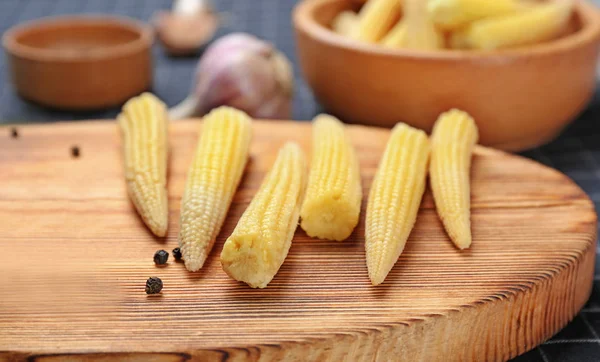 Fresh young baby corn on wooden board, closeup — Stock Photo, Image