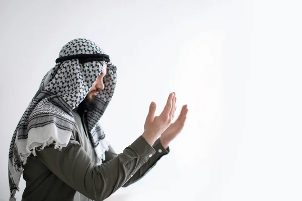 Young Muslim man praying on light background — Stock Photo, Image