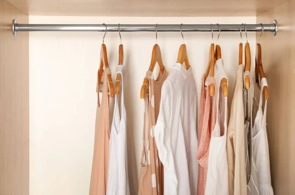 Hangers with different clothes in wardrobe closet — Stock Photo, Image