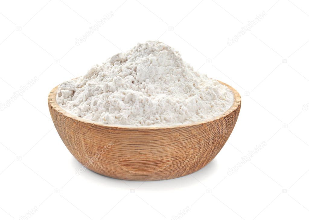 Bowl with wheat flour on white background