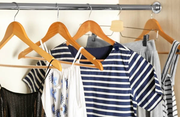 Hangers with different clothes in wardrobe closet — Stock Photo, Image