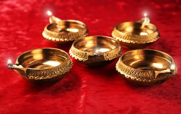 Diwali diyas or clay lamps on red fabric — Stock Photo, Image