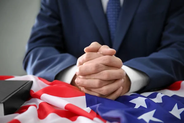 Man praying over American flag, closeup — Stock Photo, Image