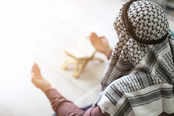 Young Muslim man praying, indoors — Stock Photo, Image