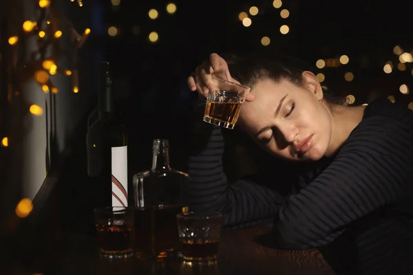 Young woman with glass of drink in bar. Alcoholism problem — Stock Photo, Image