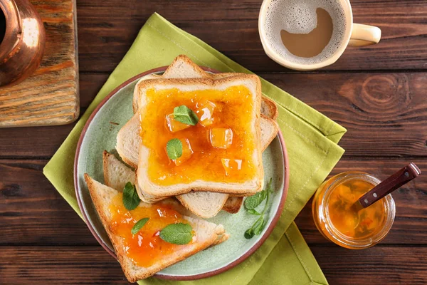 Delicious toasts with sweet jam on plate — Stock Photo, Image