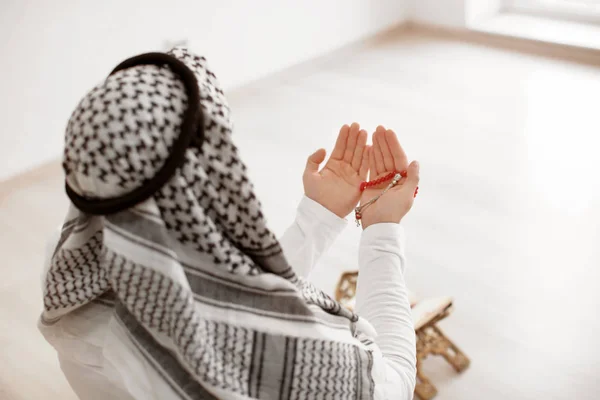 Young Muslim man praying, indoors — Stock Photo, Image