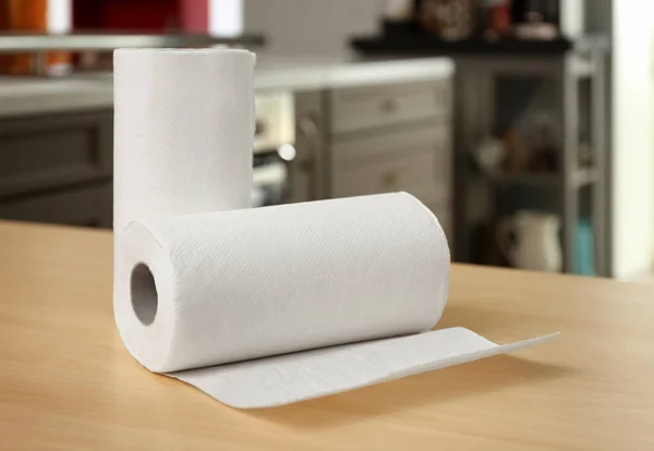 Rolls of paper towels on table indoors — Stock Photo, Image