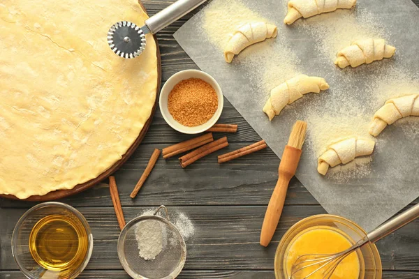 Composition with raw croissants and ingredients on table — Stock Photo, Image