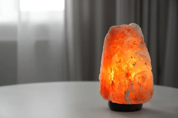 Himalayan salt lamp on table indoors