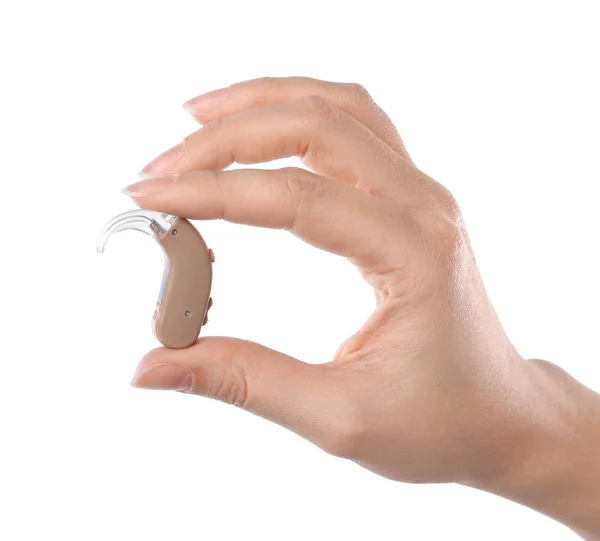 Woman holding hearing aid on white background — Stock Photo, Image