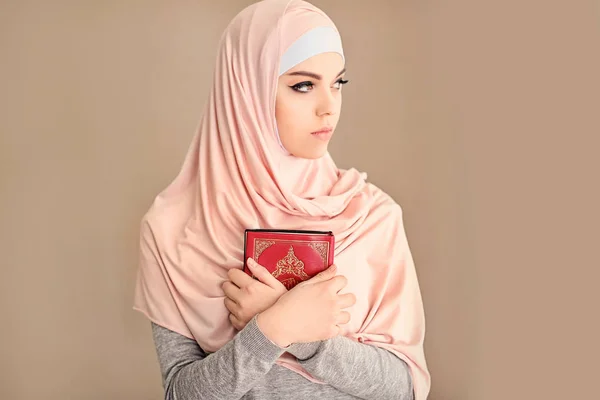 Jonge Moslimvrouw Holding Van Koran Bidden Kleur Achtergrond — Stockfoto