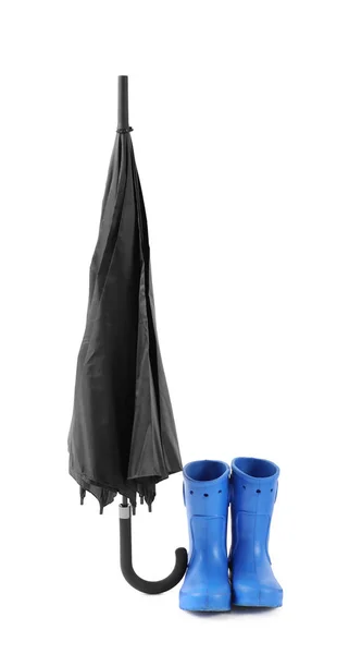 Black umbrella and gumboots on white background — Stock Photo, Image