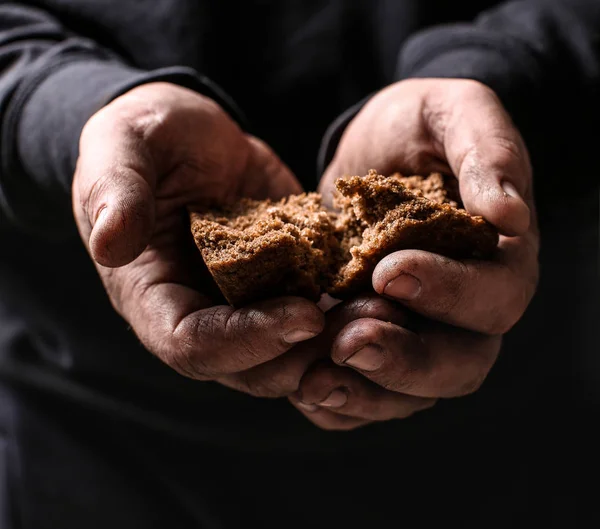 Poor man holding pieces of bread, closeup — Stock Photo, Image