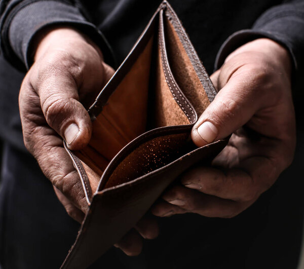 Poor man showing his empty wallet, closeup