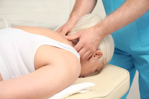 Elderly woman getting massage — Stock Photo, Image