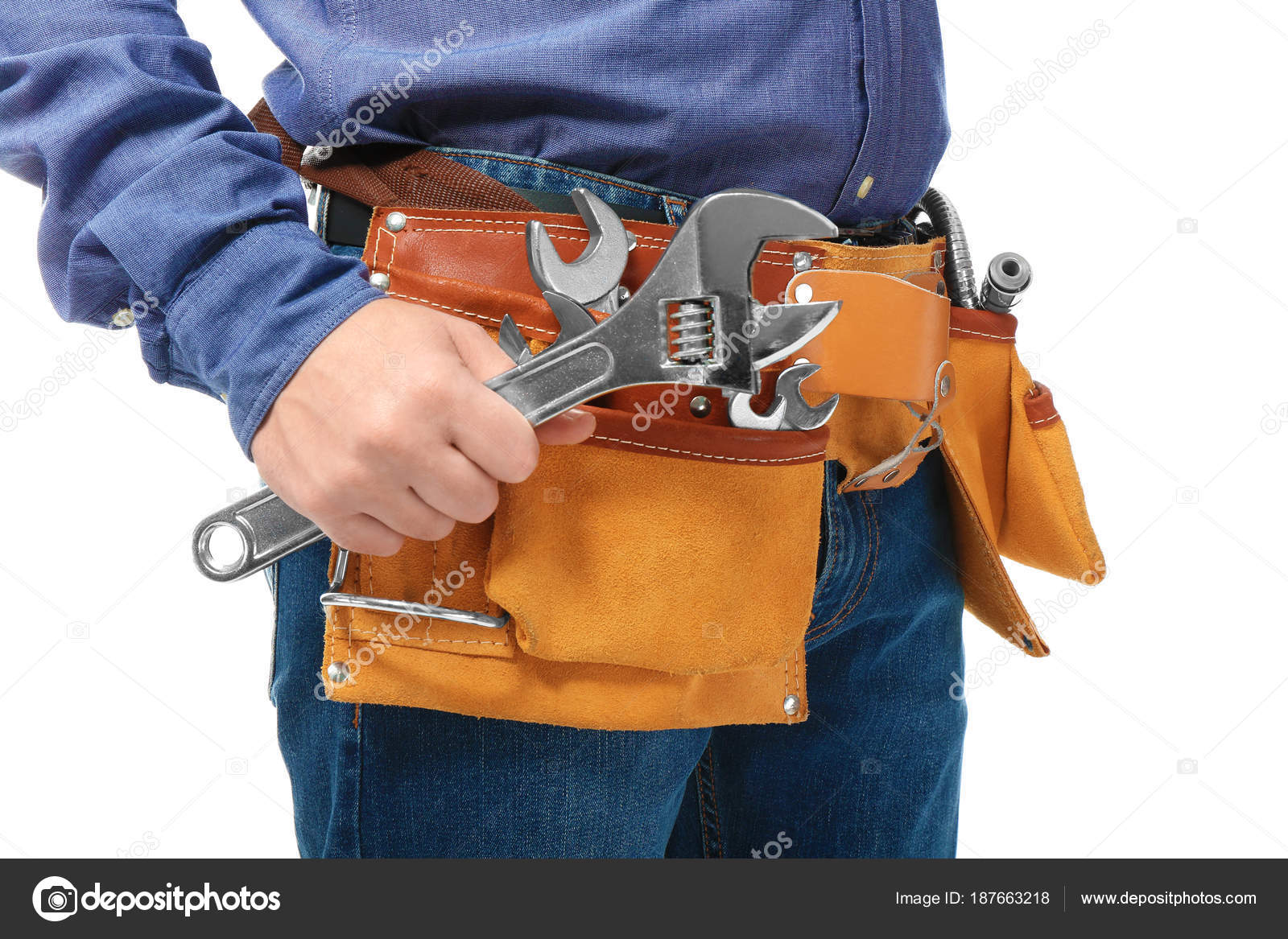 Plumber with tool belt and wrench on white background, closeup Stock