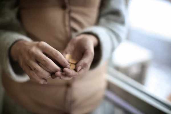 Poor woman holding coins, closeup — Stock Photo, Image