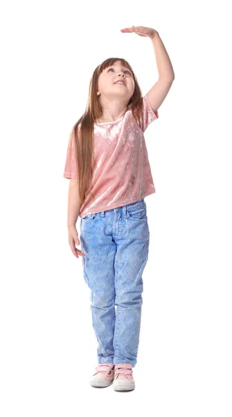 Menina bonito medindo sua altura no fundo branco — Fotografia de Stock