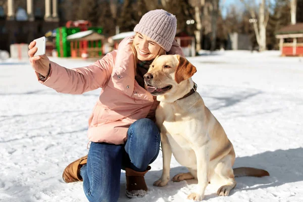 Woman taking selfie with cute dog outdoors on winter day — Stock Photo, Image