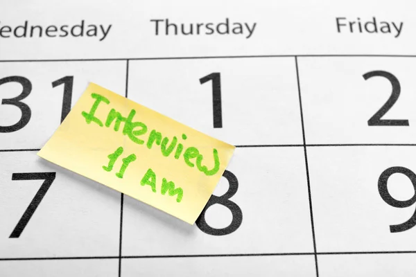 Sticky note with reminder about job interview on calendar page, closeup — Stock Photo, Image