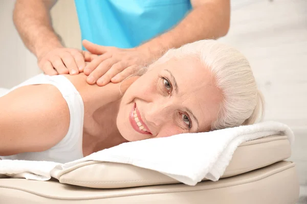 Elderly woman getting massage