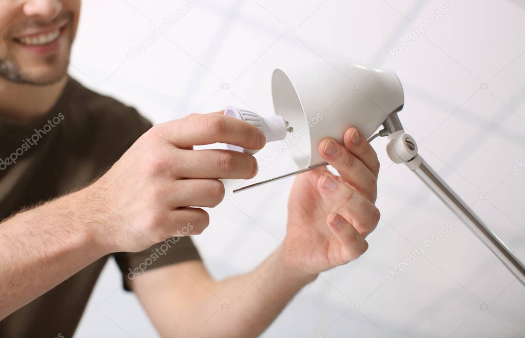 Man changing light bulb