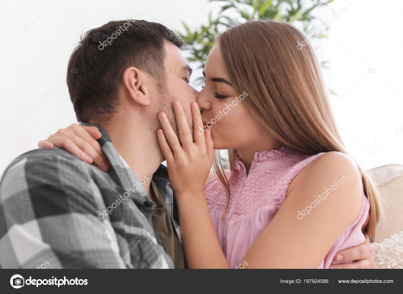Cute young lovely couple kissing at home Stock Photo by ...