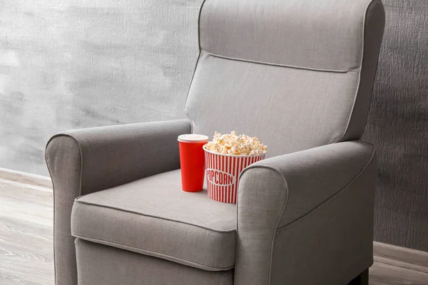 Comfortabele fauteuil met popcorn en drinken binnenshuis. Thuisbioscoop — Stockfoto