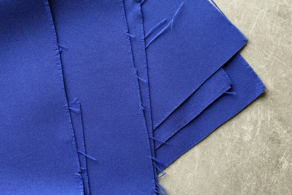 Blue textile on grey background. Fabric texture — Stock Photo, Image