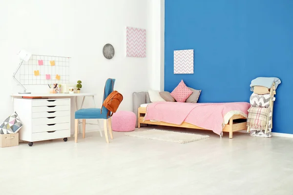 Interior of cozy children's room with table and comfortable bed — Stock Photo, Image