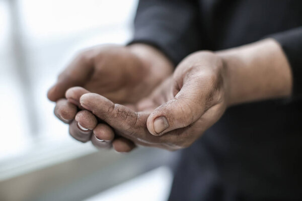 Poor man begging for money, closeup