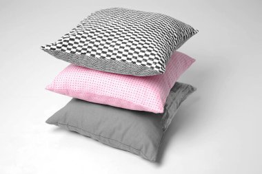 Soft decorative pillows on light background clipart