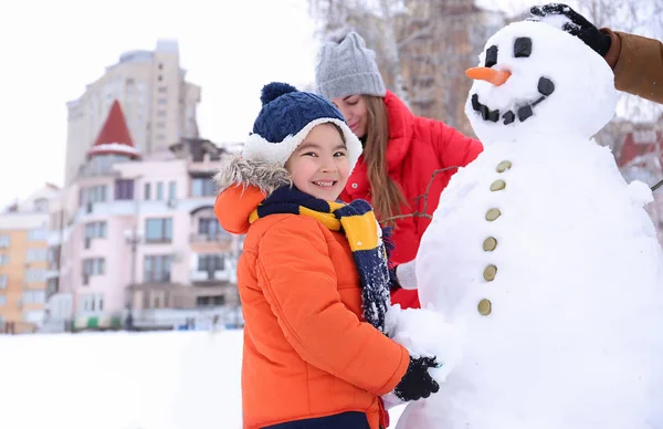 快乐家庭在公园做雪人在冬天假期 — 图库照片