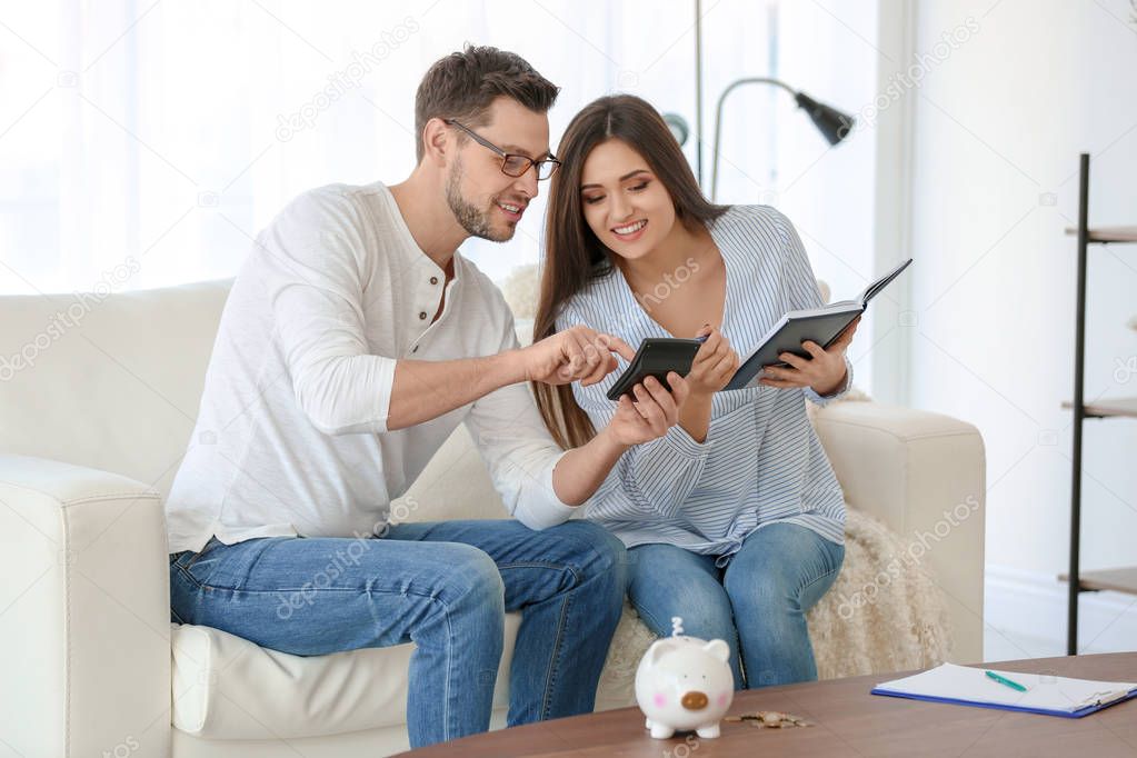 Young couple thinking over pension plan at home
