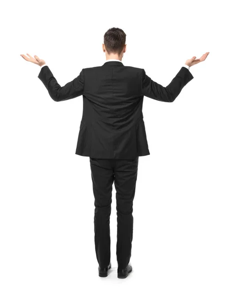 Jonge zakenman evenwicht gebaar toont op witte achtergrond — Stockfoto