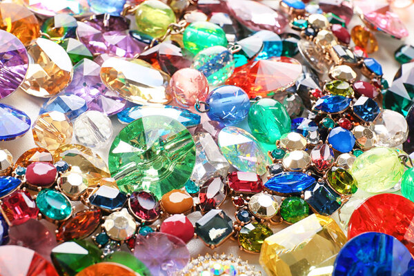 Jewellery with various colorful precious stones, closeup
