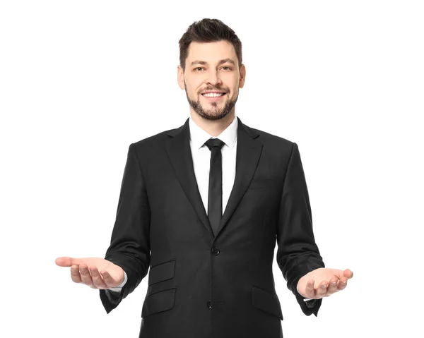 Jonge zakenman evenwicht gebaar toont op witte achtergrond — Stockfoto