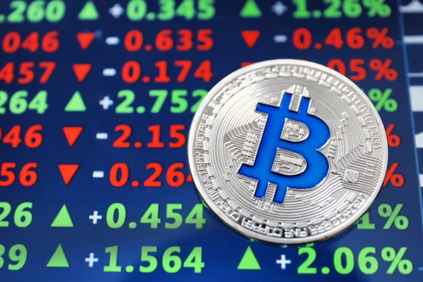Silver bitcoin on screen with exchange rates. Finance trading — Stock Photo, Image