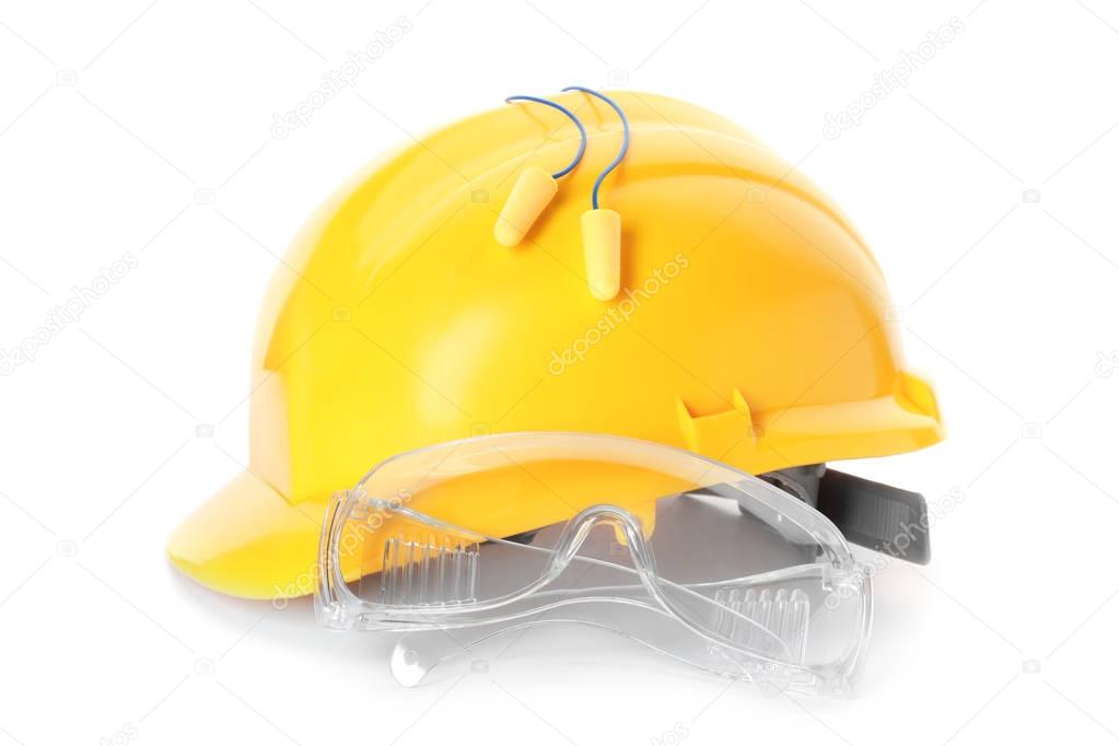 Earplugs, hard hat and goggles on white background. Hearing protection equipment