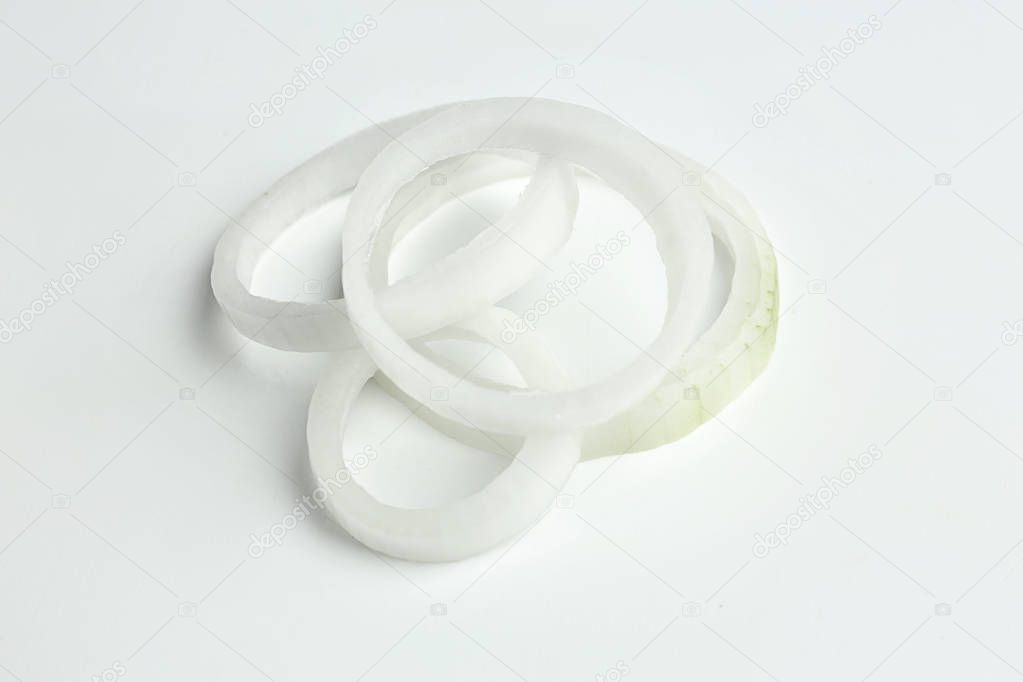 Rings of fresh onion on white background