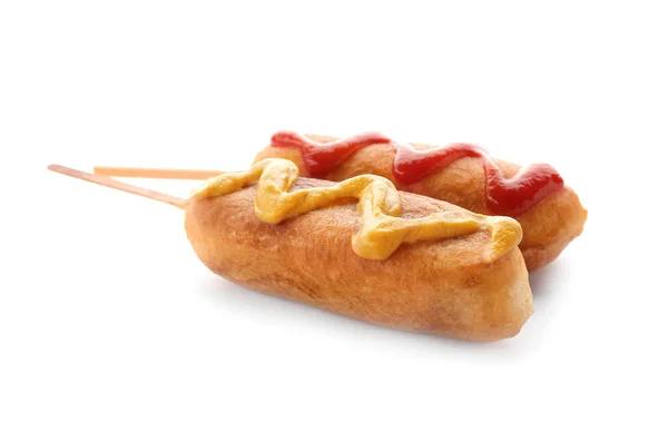 Tasty corn dog with ketchup and mustard on white background — Stock Photo, Image