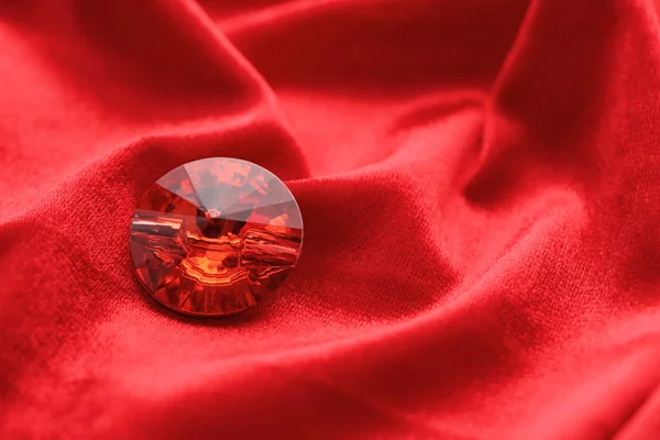 Precious stone for jewellery on red velvet