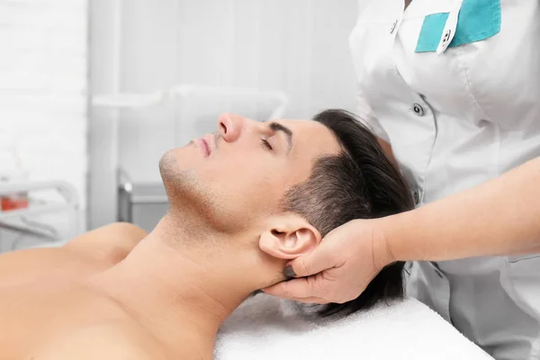 Giovane uomo con massaggio al collo — Foto Stock