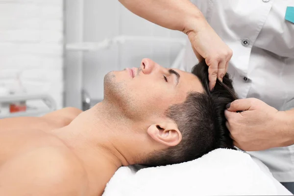 Mladý muž s masáží hlavy — Stock fotografie