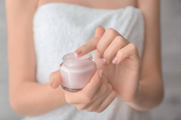  woman with jar of hand cream